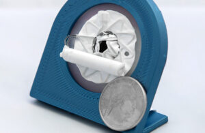 Adona Medical's Delphi adjustable heart shunt implant with a quarter for scale.