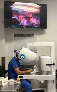 An image of a surgeon using a robotic surgery platform to perform an aortic valve replacement procedure.