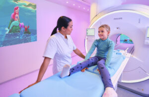 This is a Philips mareting image showing a kid getting ready for an MRI with a Disney Little Mermaid theme provided through Philips Ambient Experience.