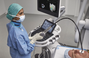 This is a Philips marketing image showing a health provider using its AI-powered, ultrasound-based system to measure mitral regurgitation.